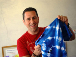 One of our volunteers - a happy man - looks at his tie-dye t-shirt