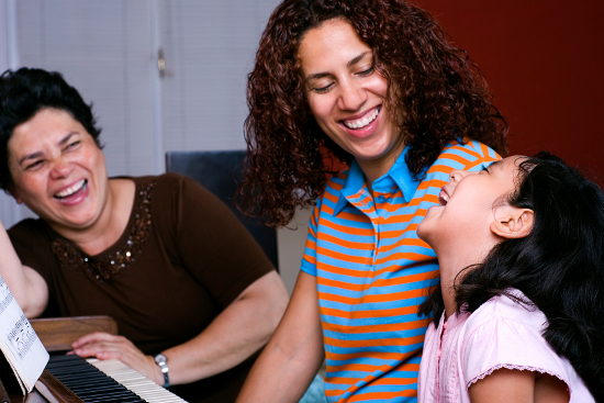 Three generations of women share a laugh