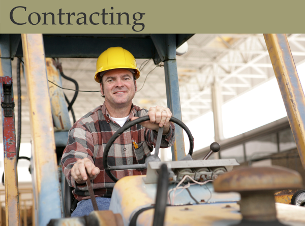 A contractor smiles atop a bulldozer